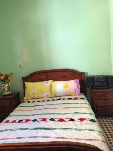 a bed with colorful pillows on it in a bedroom at LoveWave House in Agadir