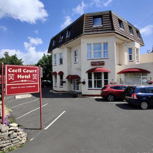 a building with a sign in a parking lot at Cecil Court Hotel in Bournemouth