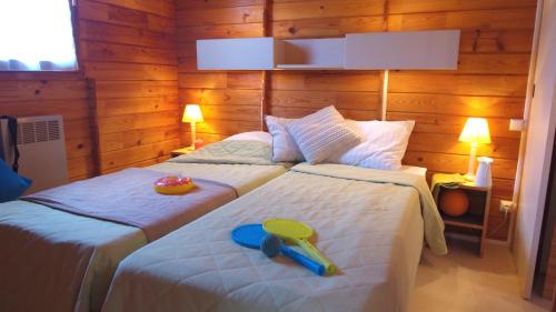 a bedroom with two beds with a tray on the bed at VVF Cantal Salers Vendes in Bassignac