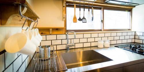 a kitchen with a sink and a counter top at Misorano Chalet in Hakuba