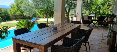 ein Holztisch und Stühle auf einer Terrasse in der Unterkunft Villa Rapkinja in Mundanije