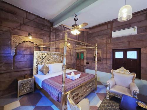 a bedroom with a bed and a chair in a room at Amritara Manak Haveli, Jodhpur in Jodhpur