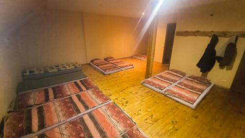 a room with three beds in it with the light shining at Jaunrūtiņas dīķis in Salaspils