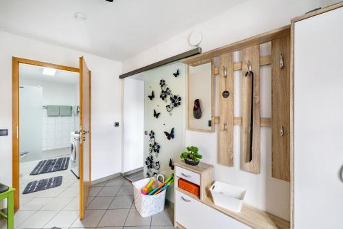 a bathroom with a door open to a bathroom with bats on the wall at Leas Ferienwohnung in Aichen