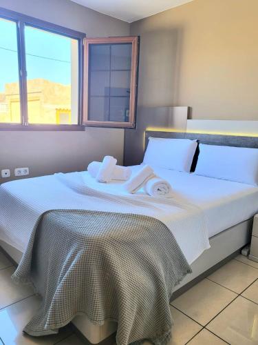 a bedroom with a bed with towels on it at ENJOY House with Large Pool & Jacuzzi in Los Estancos