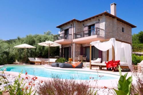 a villa with a swimming pool in front of a house at Villa Agapi - Spacious Boutique Villa with Private Pool close to the sea in Sivota