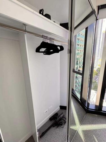 a room with a wall with a shelf with shoes at 1Br City View apt near SthnCrs Wifi Pool Gym in Melbourne