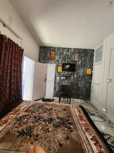 a living room with a large rug on the floor at Wings Cottage in Ooty