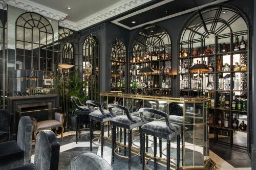 a bar with a bunch of bar stools at The Franklin London - Starhotels Collezione in London