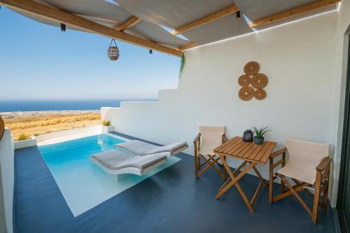 a room with a table and chairs and a swimming pool at Salida Del Sol Santorini in Éxo Goniá