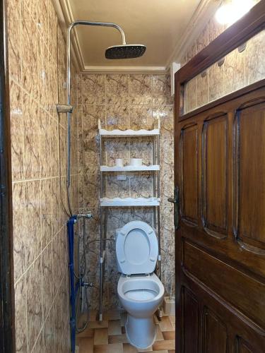 a small bathroom with a toilet and a shower at Maison EZ in Rabat
