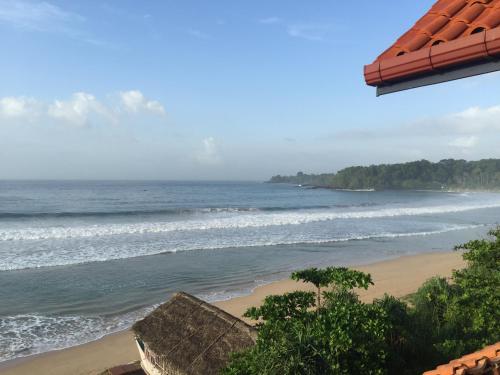 a view of the ocean from a beach at Talalla Bay Beach in Talalla