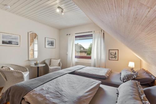 a bedroom with a large bed and a window at Ferienwohnung Am Orpeturm in Marsberg