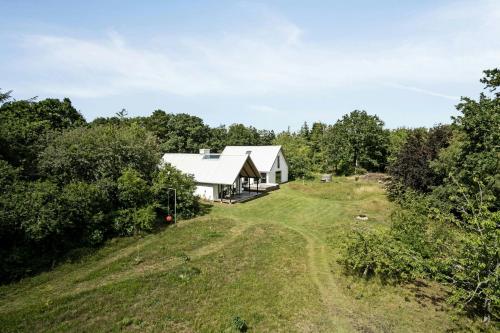an aerial view of a white house on a hill at Fjord-Close Cottage With Beautiful View in Hemmet