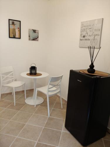 a white table and chairs and a table and a table and chairs at Albachiara in Sacrofano