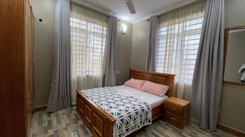 Ένα ή περισσότερα κρεβάτια σε δωμάτιο στο Pagic Homes Luxury in Kilimanjaro