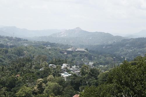 a town in a valley with mountains in the background at Cirute' Talwatte, Kandy in Kandy