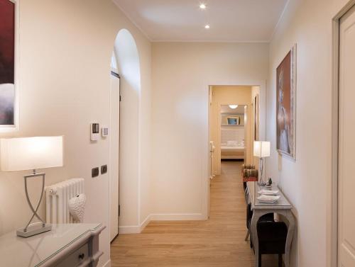 a hallway with a table and chairs in a room at AD MY HOME in Cortona