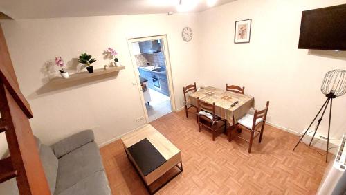 a living room with a table and a dining room at Maison centre ville in Nogent-sur-Vernisson