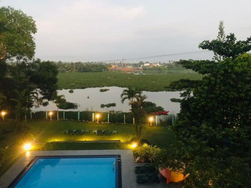 a view of a backyard with a swimming pool at Ayurveda Spring Of Life Resort in Piliyandala