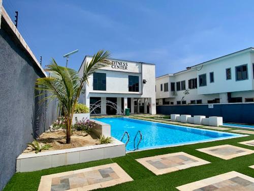 a swimming pool in front of a building at House 8 in Lekki