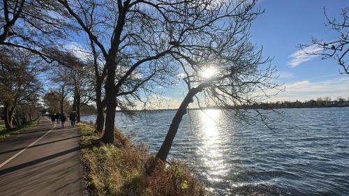 people walking along a path next to a lake at Nubian Life Nile View in Aswan