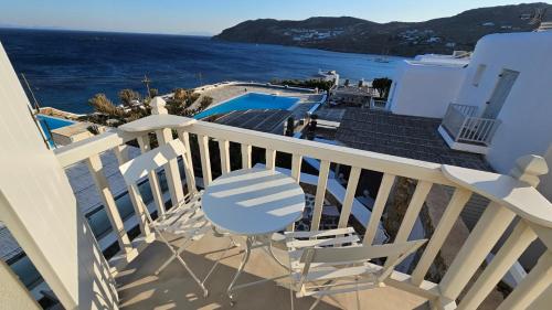 a balcony with chairs and a view of the ocean at Villa Spika with seaview and shared pool in Kalo Livadi