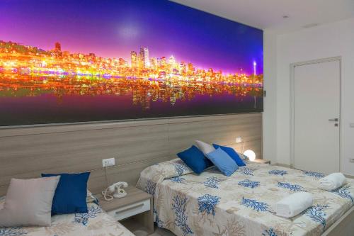 a bedroom with a large wall mural of a city at Hotel America in Scafati
