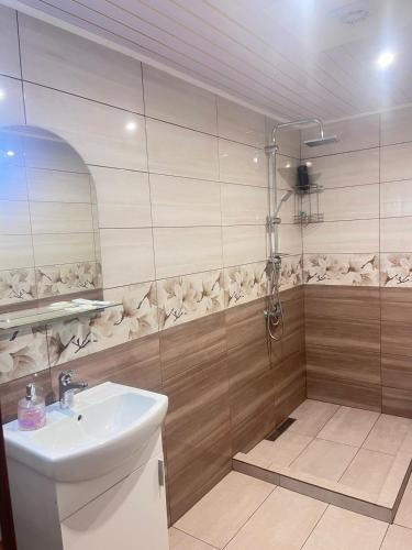 a bathroom with a shower and a sink at Jenny House in Sapareva Banya