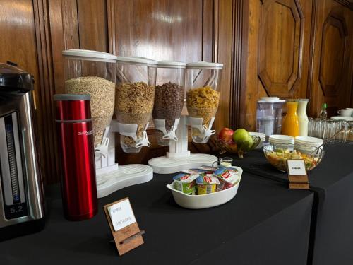 a table with containers of food and other food items at Travels Hotel in Osorno