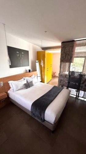 a bedroom with a large bed in a room at Citta di Lume Suites & Lofts in Porto-Vecchio