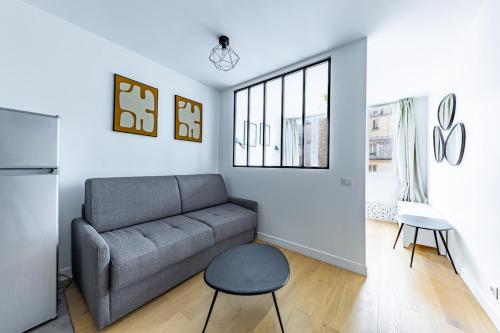 a living room with a couch and a window at Comfortable Apartment , Porte-Dorée District, Paris in Paris
