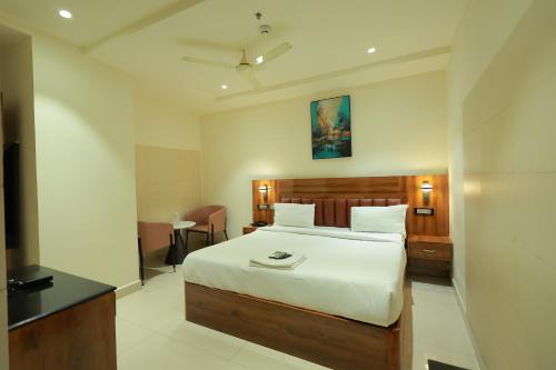a bedroom with a large bed in a room at HOTEL SVM GRAND RAMANTHAPUR in Hyderabad