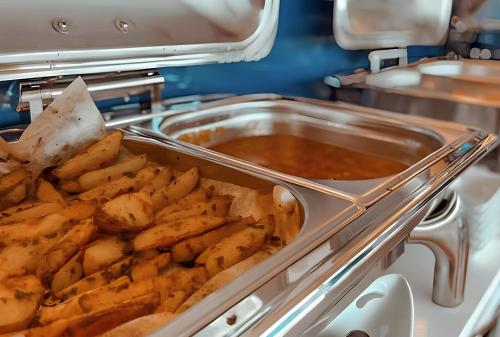 a tray of french fries and a pot of stew at SeaView Suite with panoramic view in Batumi