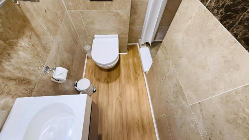 a bathroom with a toilet and a sink at Osborne Aparthotel in Eastbourne