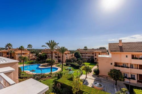 an aerial view of an apartment complex with a swimming pool at Jardines de Santa Maria Golf in Marbella