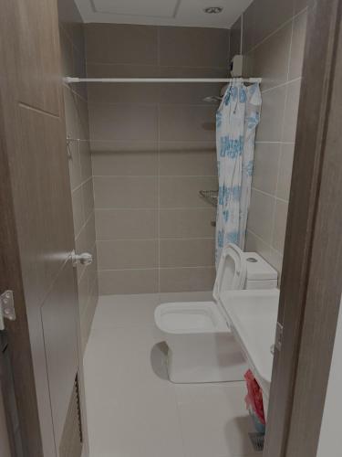 a small bathroom with a toilet and a shower at Sitari Condo Bacolod in Bacolod