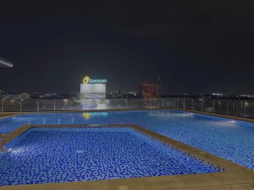 a swimming pool on top of a building at night at Sitari Condo Bacolod in Bacolod