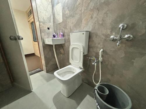 a bathroom with a toilet and a shower and a sink at hotel elevate suites in Nagpur
