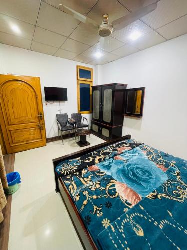 a room with a large bed in a room at Green land hotel in Mingāora