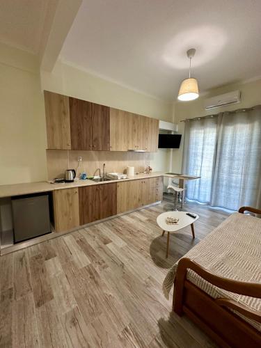 a large kitchen with wooden cabinets and a table at ESTIA Dionysos in Drama