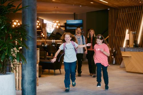 a group of people walking down a hallway at Peaks Place Apartments & SPA in Laax