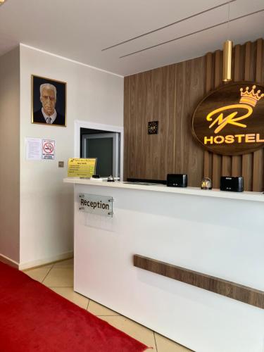 a hotel reception desk with a sign on the wall at Hôtel Mon Royaume in Skikda