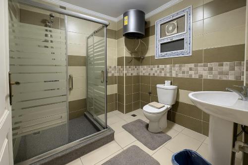 a bathroom with a shower and a toilet and a sink at 903 . Spacious 3BR Apt. 2 Baths Gated Community in Sheikh Zayed
