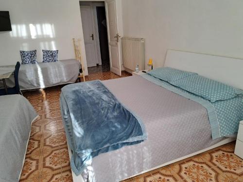 a bedroom with two beds in a room at Alloggio Turistico RELAX in Civitavecchia