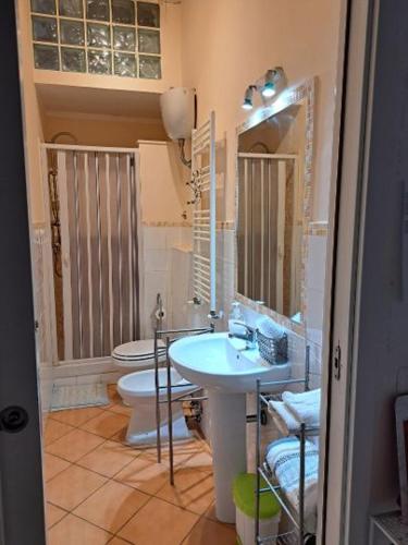 a bathroom with a sink and a toilet at Alloggio Turistico RELAX in Civitavecchia