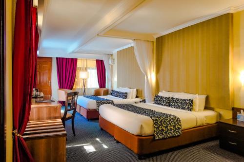 Ένα ή περισσότερα κρεβάτια σε δωμάτιο στο The Grand Royal Swiss Hotel