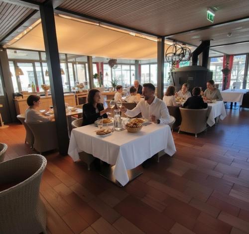 a group of people sitting at tables in a restaurant at Landhotel Schustermühle in Seefeld-Kadolz