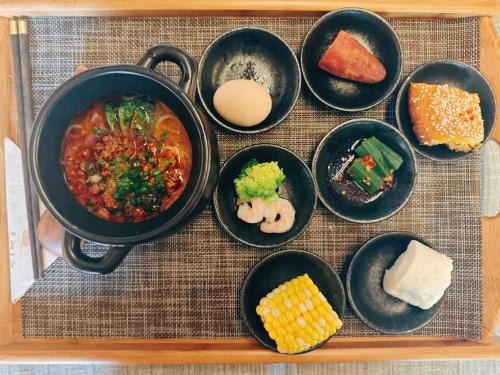 a group of bowls of food on a tray at Yyj Island Garden Resorts Lijiang in Lijiang