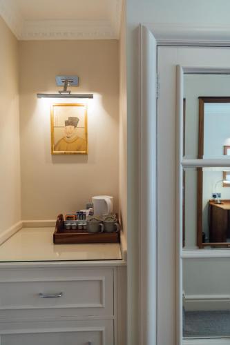 a kitchen with a counter with a plate of food at The Woburn in Woburn